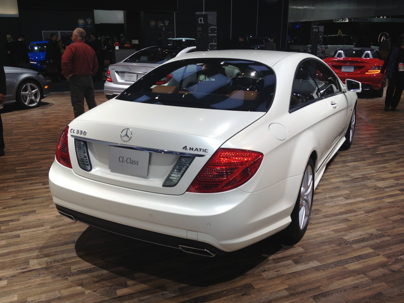 White luxury coupe rear view with 4MATIC badge and dual exhausts