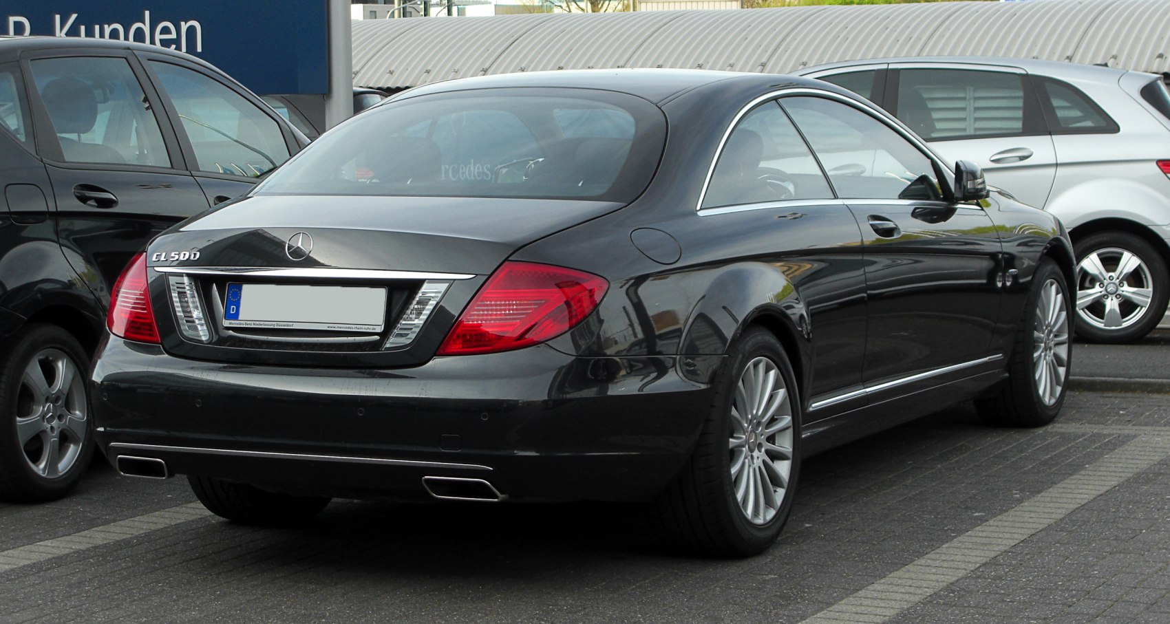Rear view luxury coupe with distinctive taillights and dual exhaust outlets