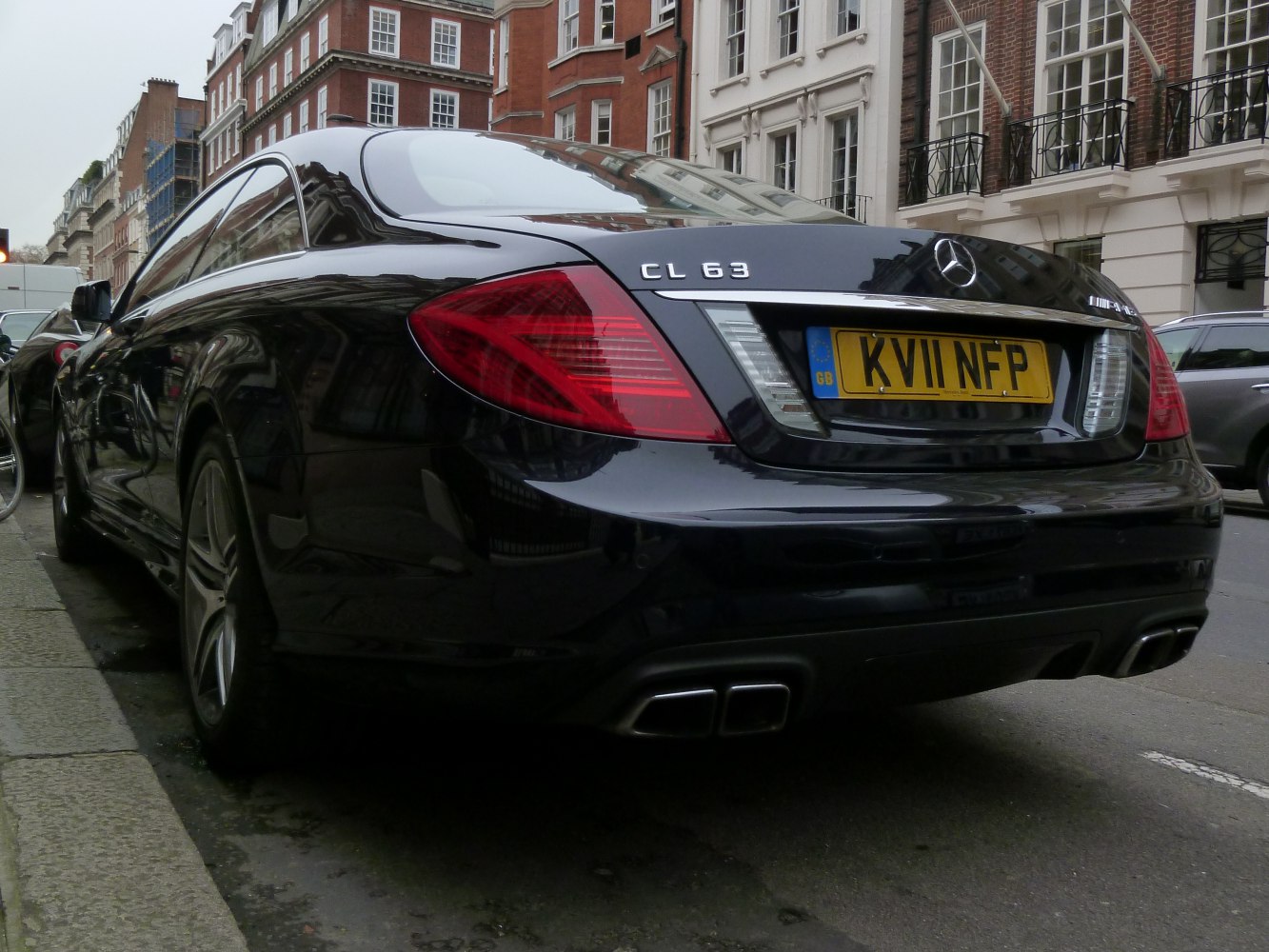 Rear side view showing quad exhaust and tail light design