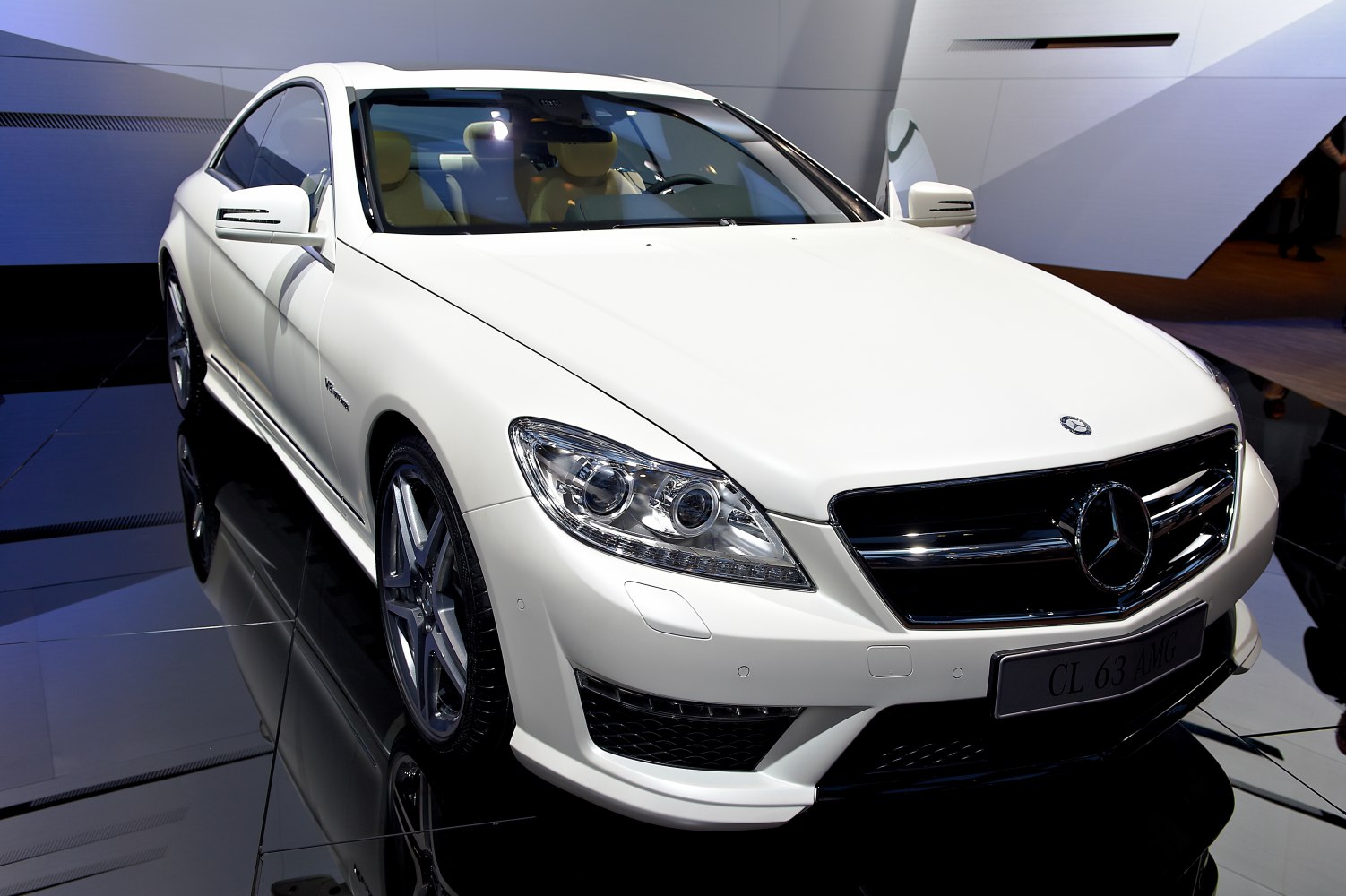 White luxury coupe front view with AMG grille and LED headlights