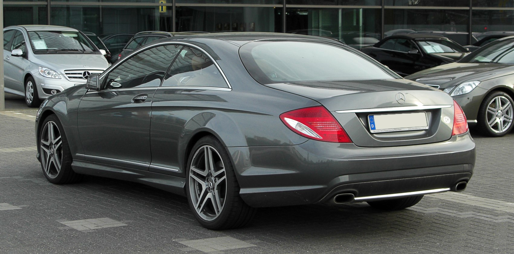 Rear and side profile of luxury coupe with alloy wheels and dual exhaust