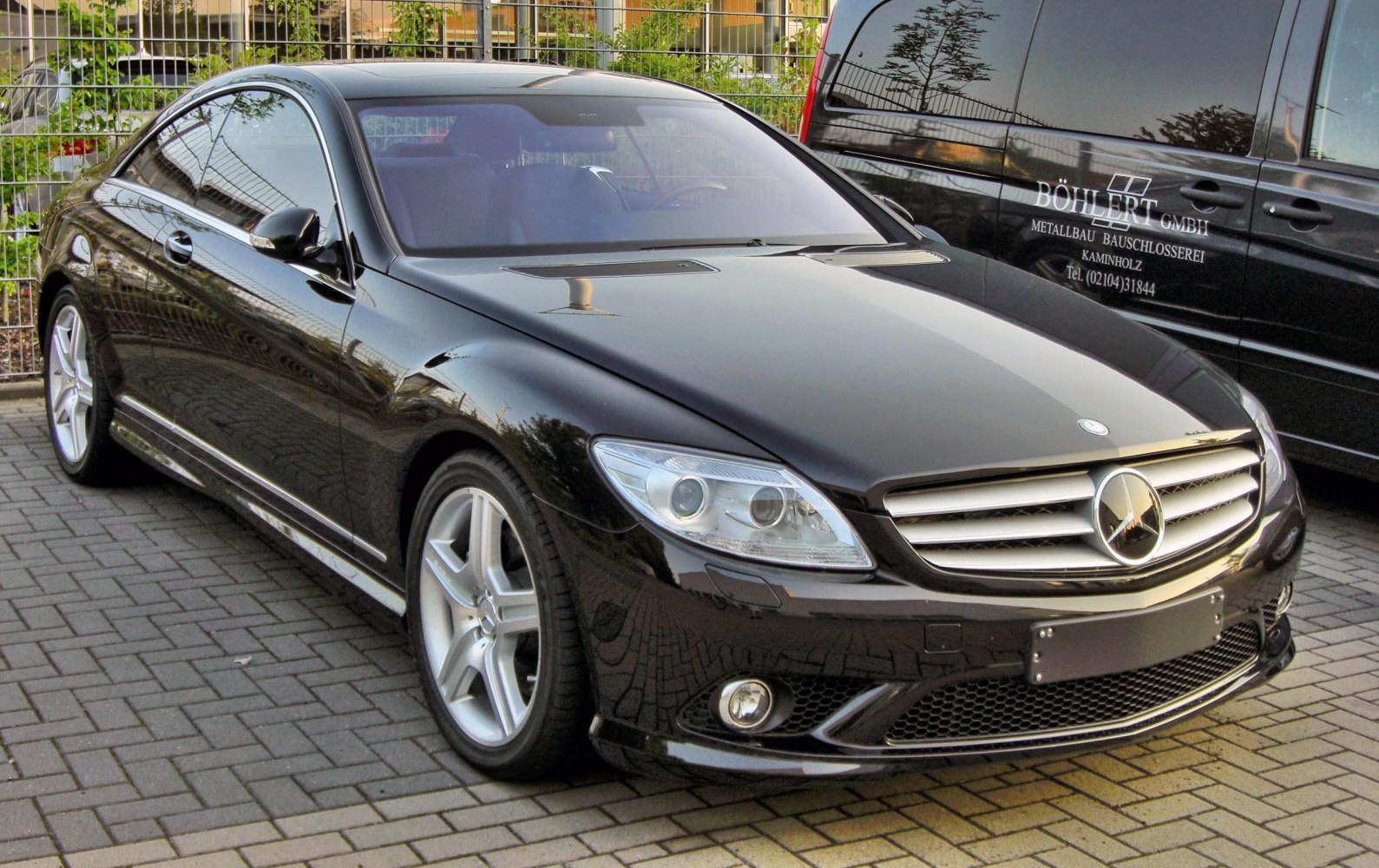 Front profile with distinctive headlights and grille of a luxury coupe