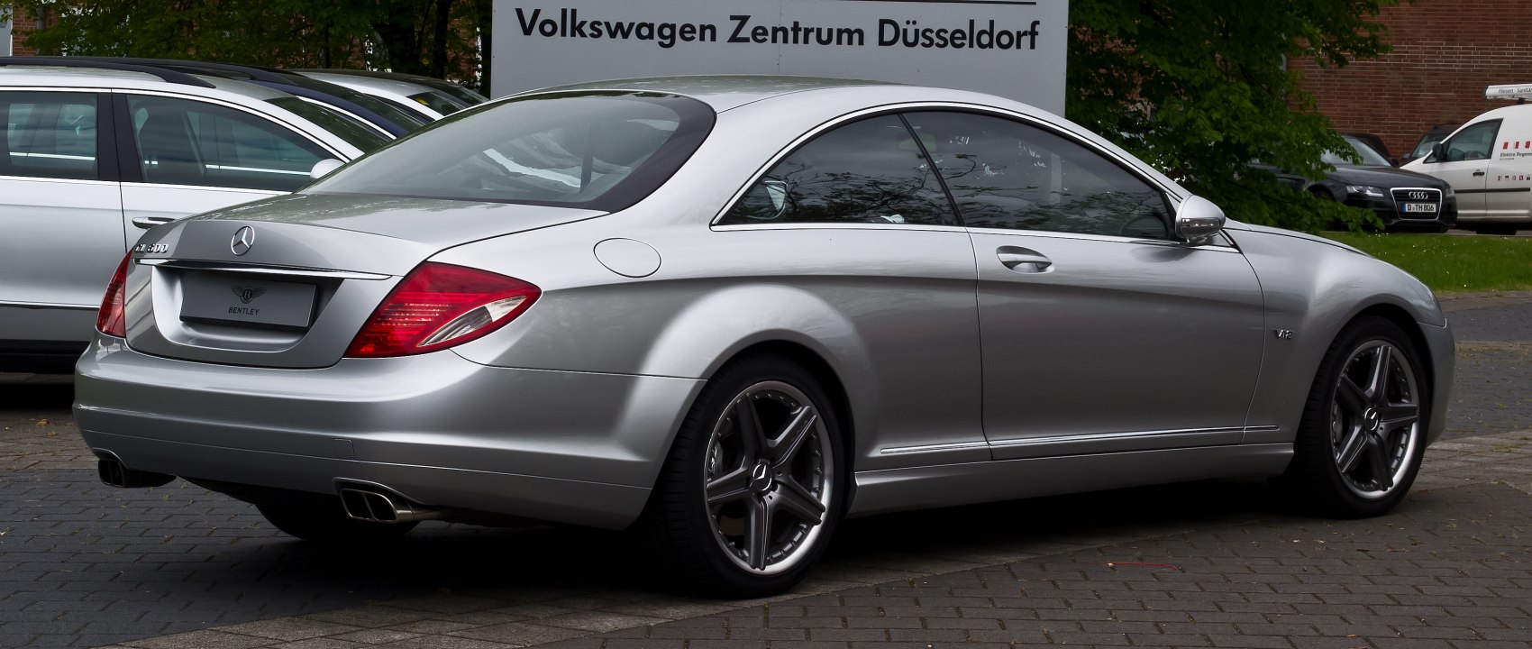 Rear and side profile of a luxury coupe with distinctive tail lights and alloy wheels
