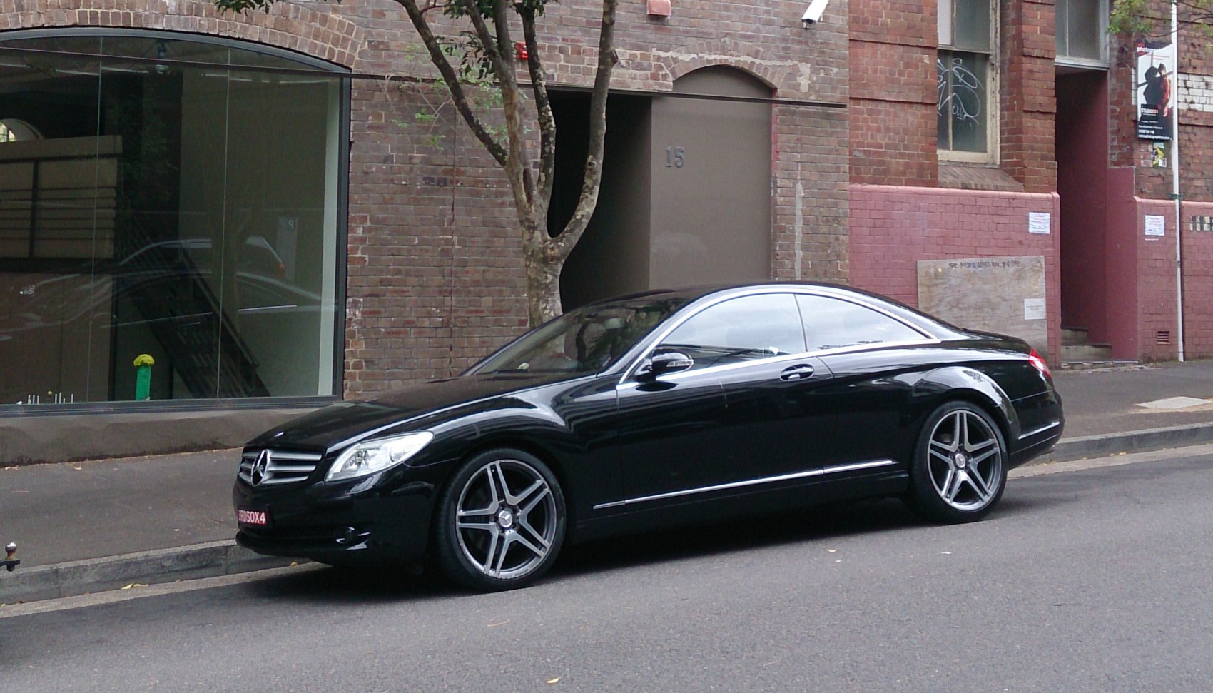 Black luxury coupe with LED headlights and alloy wheels