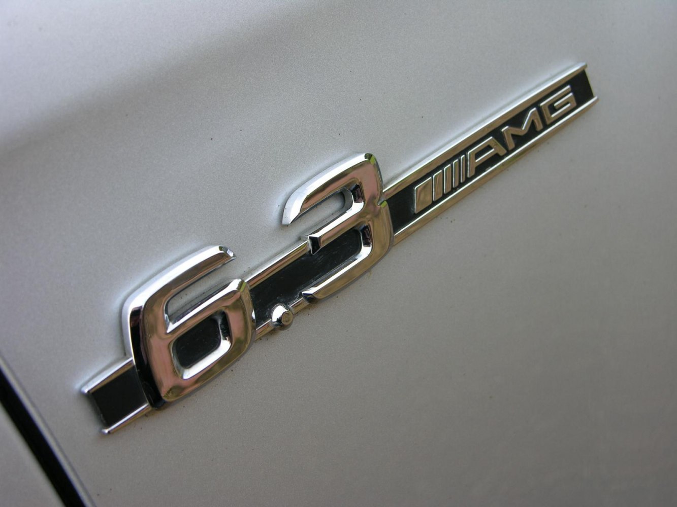 Close-up of 6.3 AMG badge emblem on car body