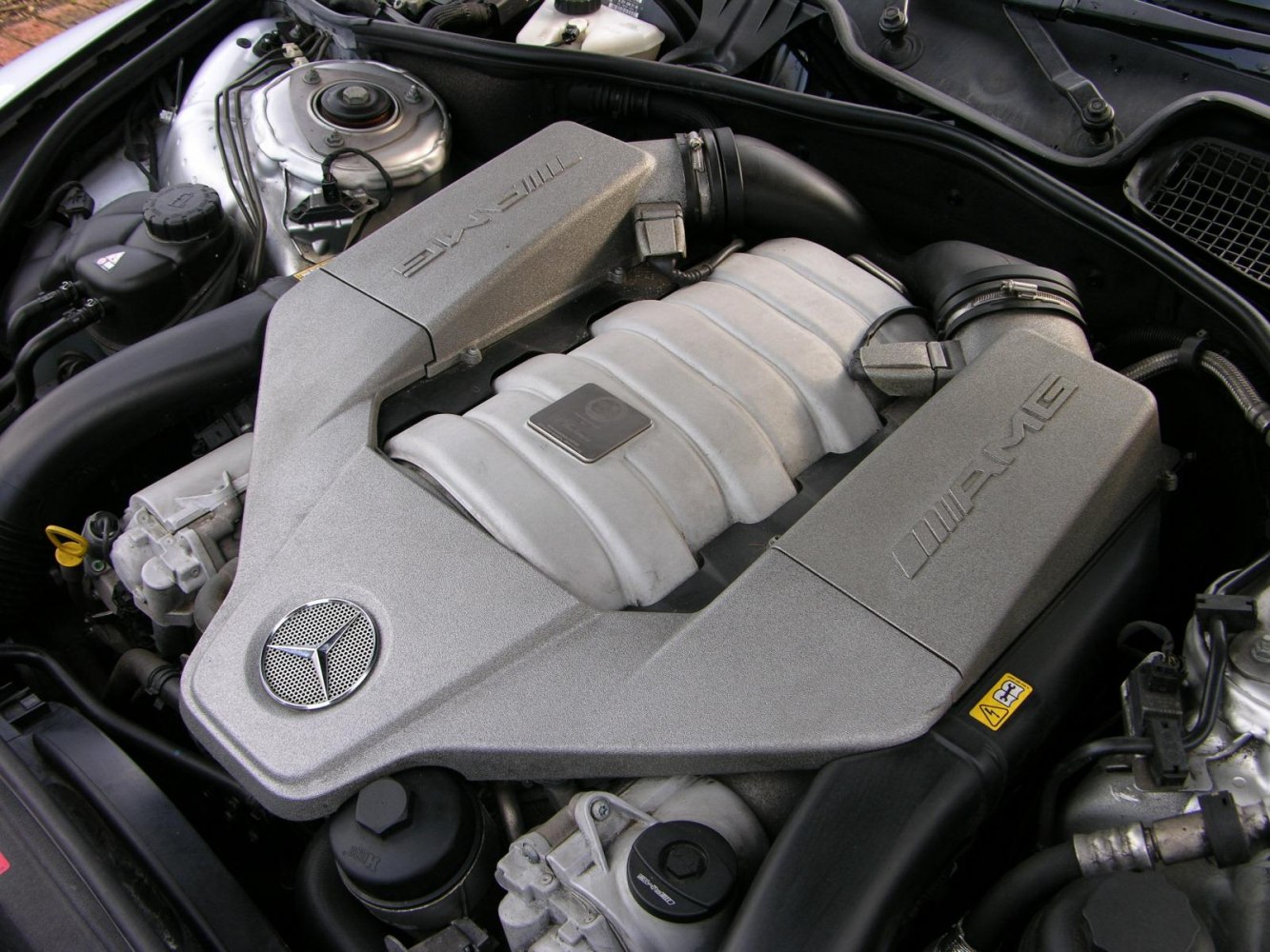 Close-up of a high-performance AMG engine with Mercedes emblem.