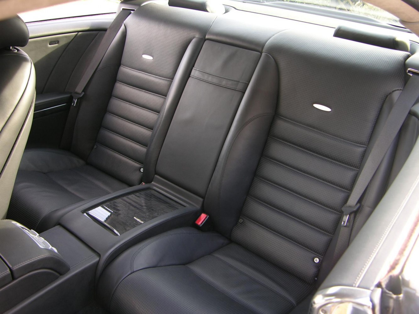 Black perforated leather rear seats with center armrest and seat belts
