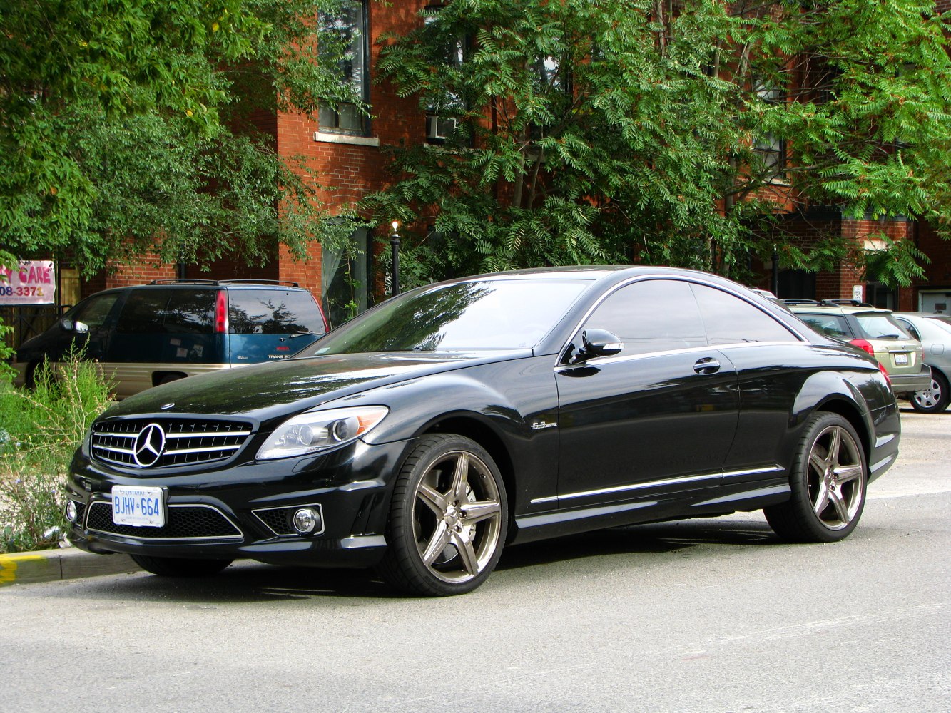 Black luxury two-door coupé with AMG wheels and tinted windows