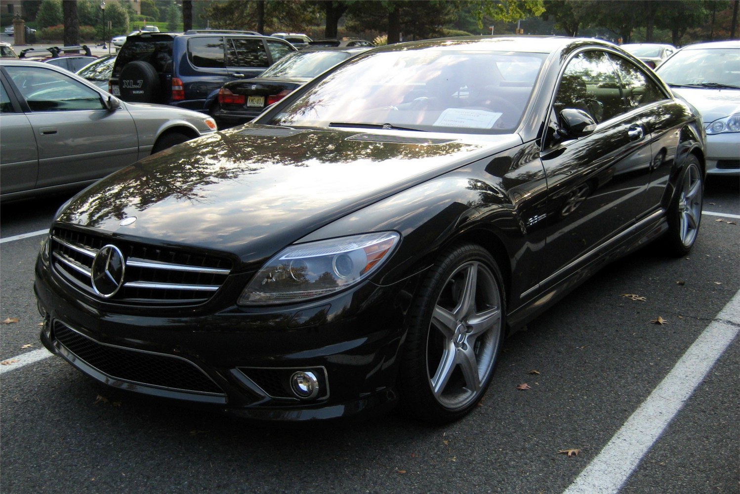 Black luxury coupe with bold grille and five-spoke alloy wheels