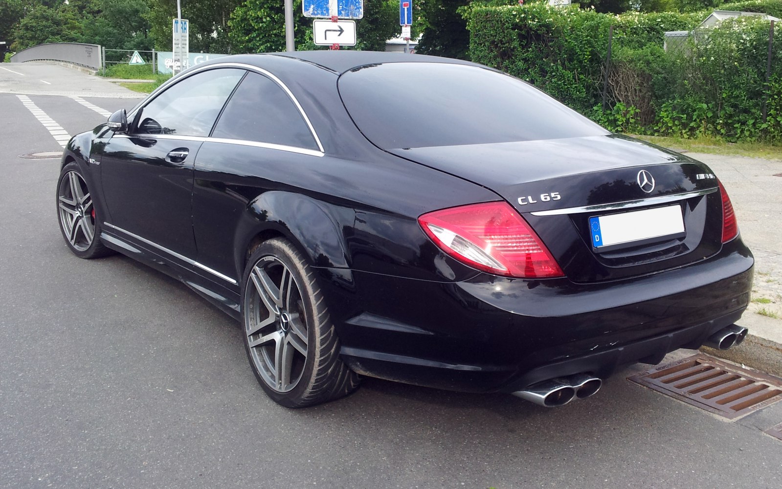 Black coupe rear with quad exhaust tips and LED tail lights