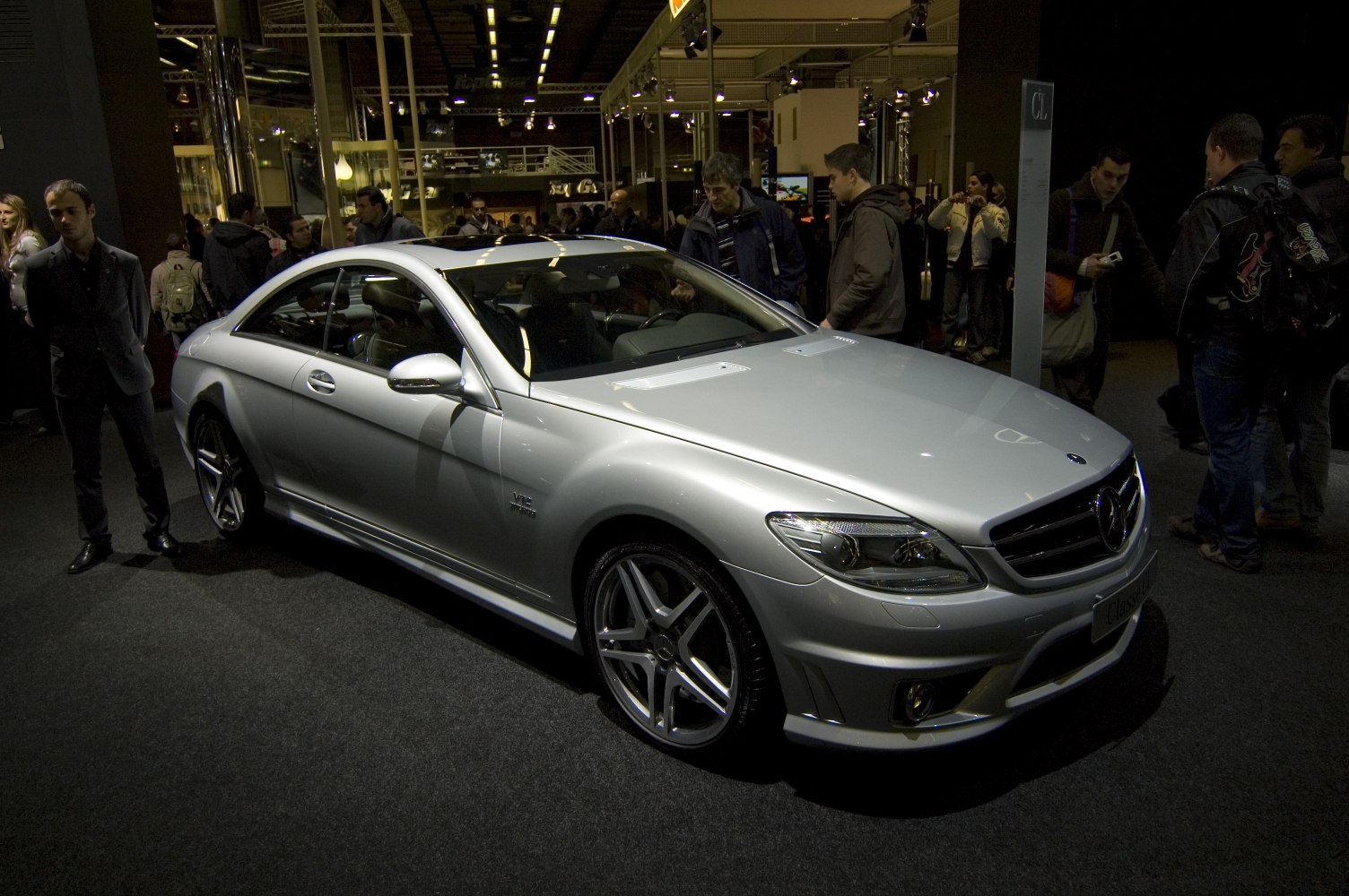 Silver luxury coupe front side with V12 badge and AMG alloy wheels