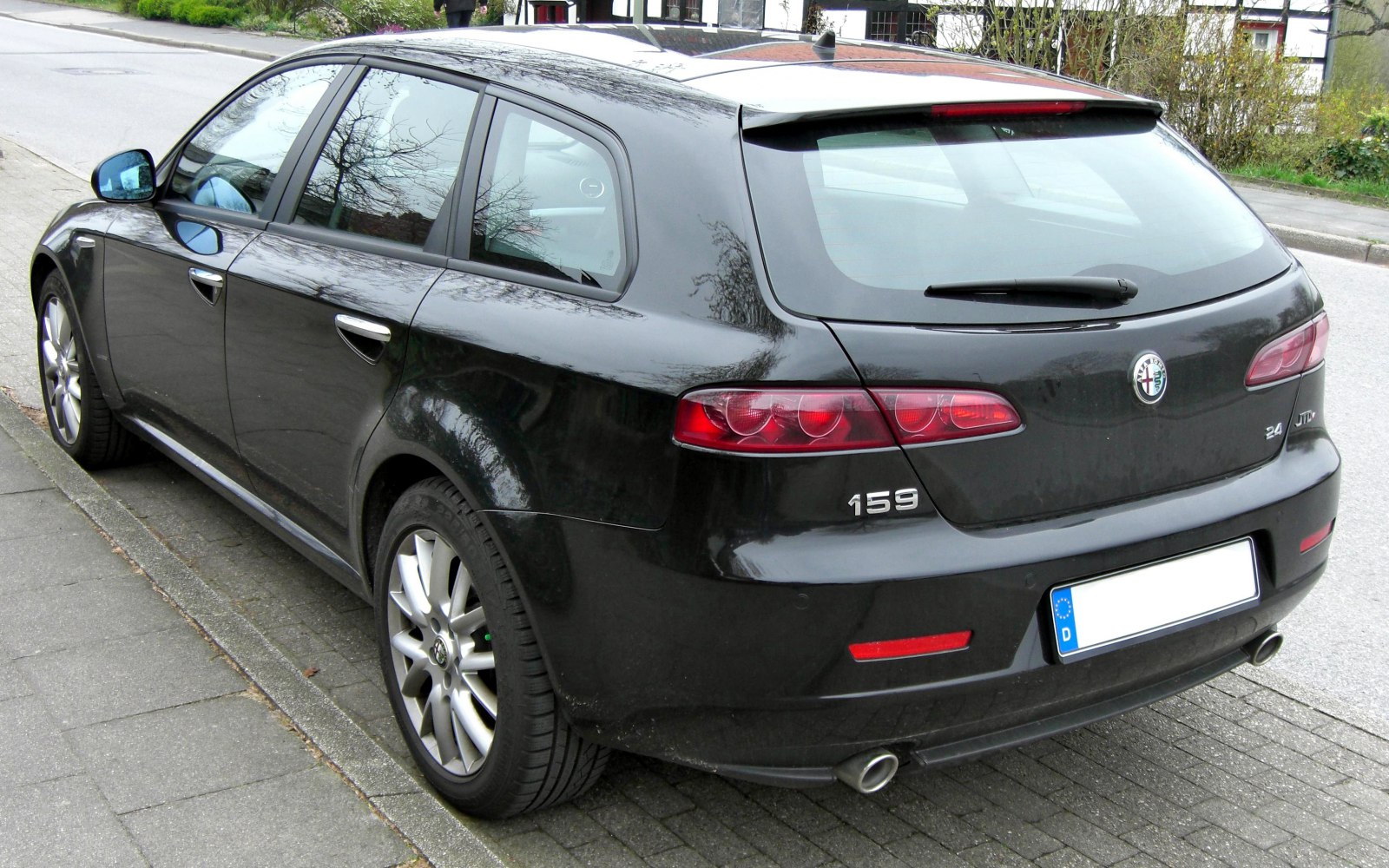 Rear view of a sleek station wagon with dual exhaust and distinctive taillights.