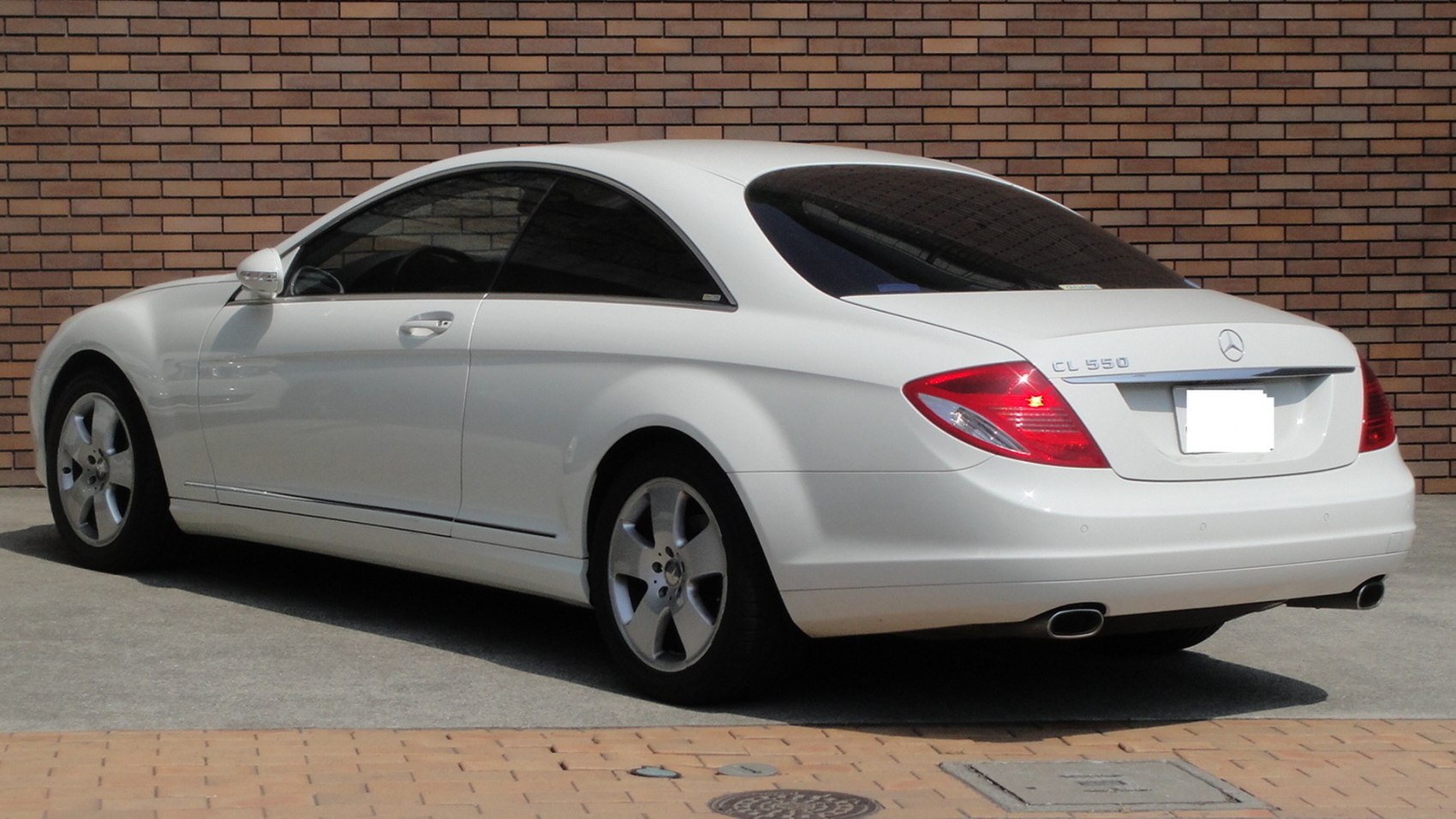 Rear side profile of a luxury coupe with sleek lines and distinctive taillights