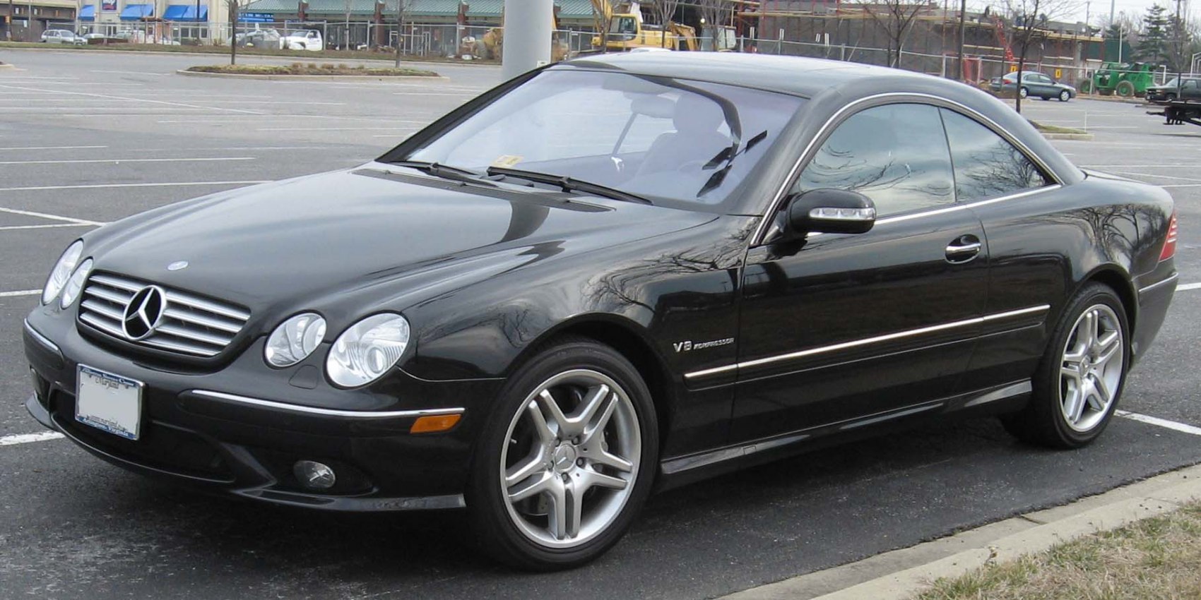 Sleek V8 coupe with quad headlights and alloy wheels.
