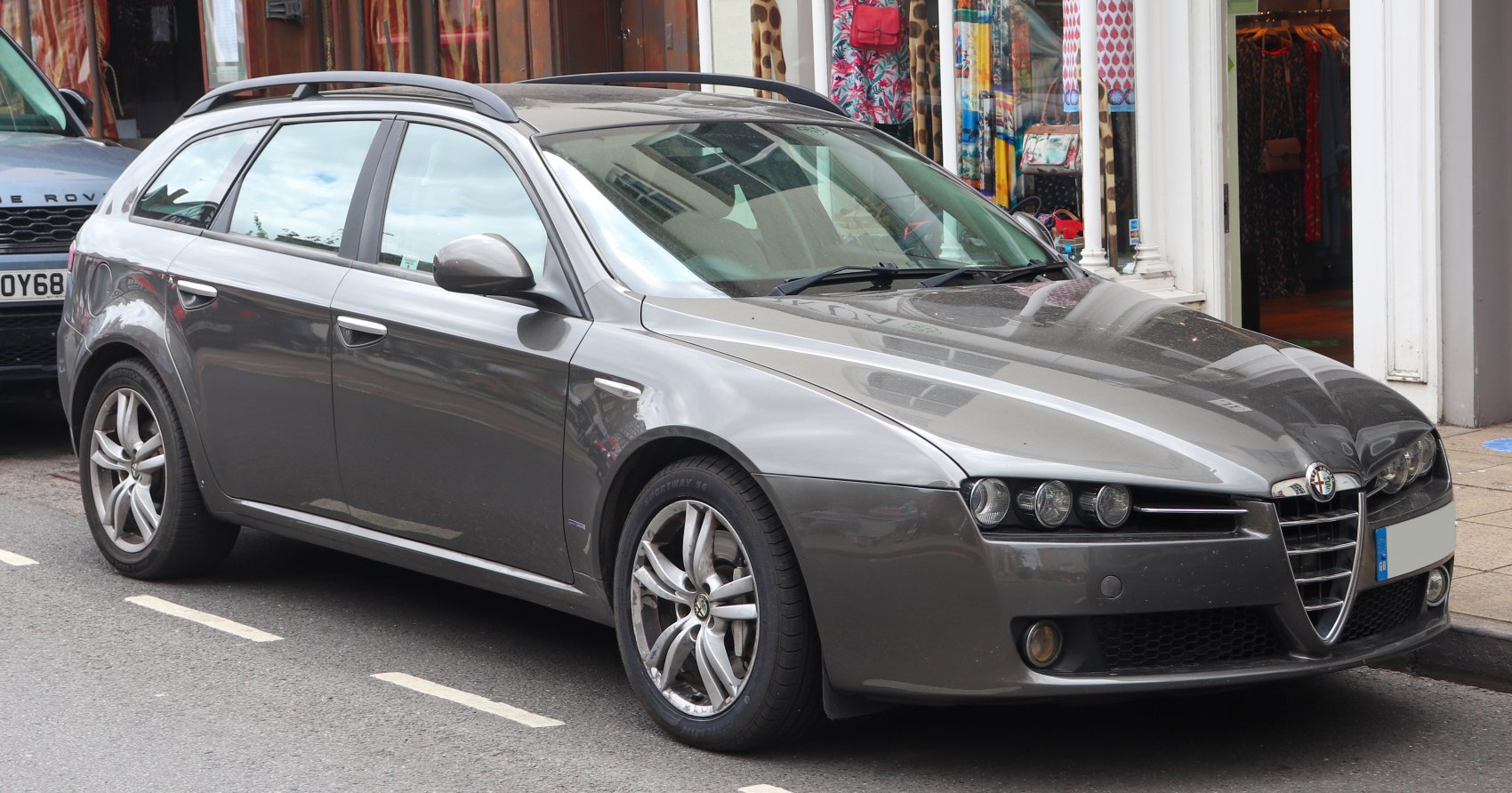 Front-side view of a sporty station wagon with distinctive headlamps and alloy wheels
