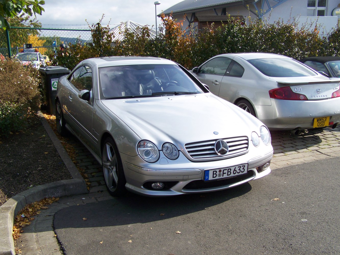 Silver coupe with dual round headlights and sporty alloy wheels.