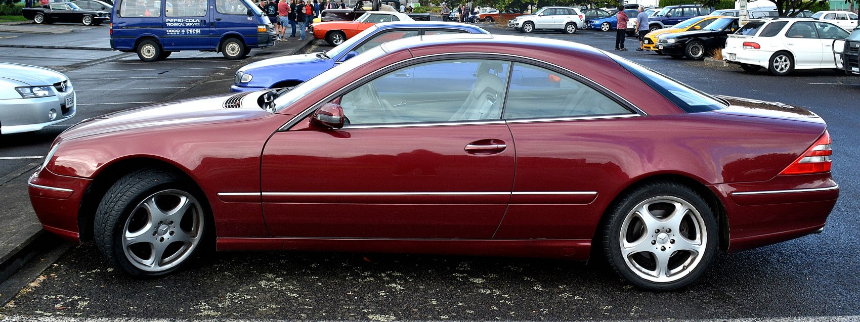 Sleek luxury coupe side profile with alloy wheels