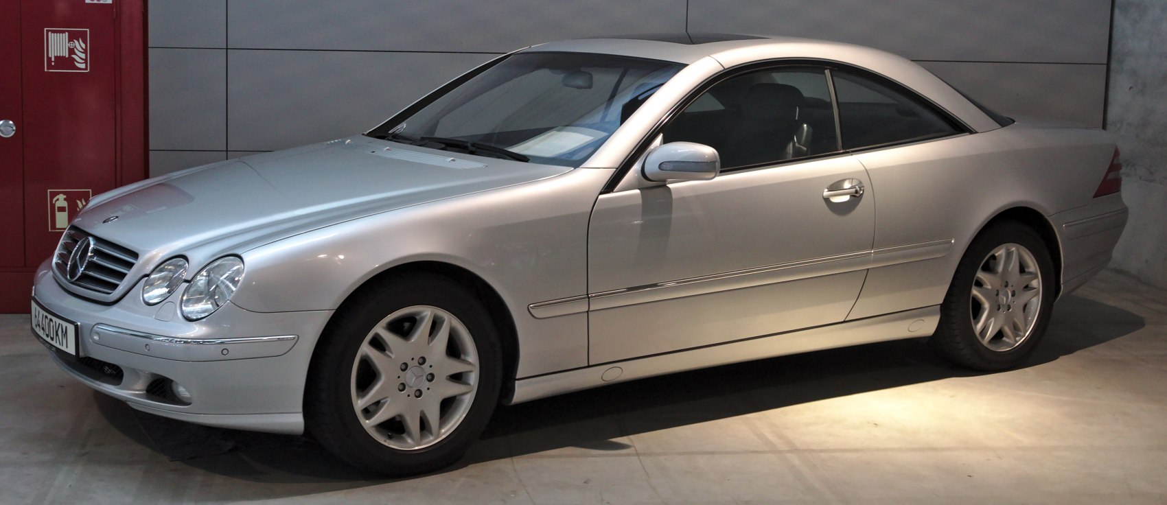Silver two-door luxury coupe with alloy wheels side profile