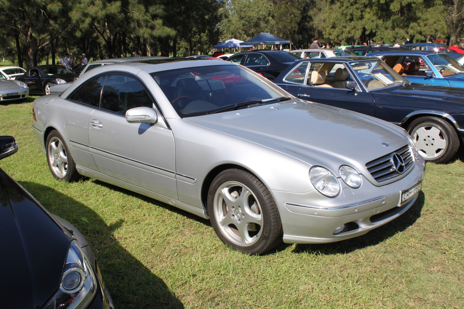 Silver luxury coupe with quad headlights and sleek aerodynamic design