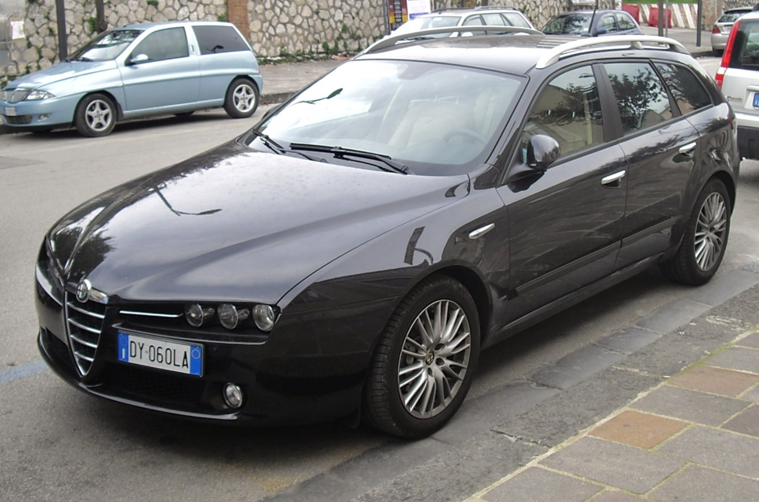 Front angle view of a station wagon with roof rails and multi-lens headlights