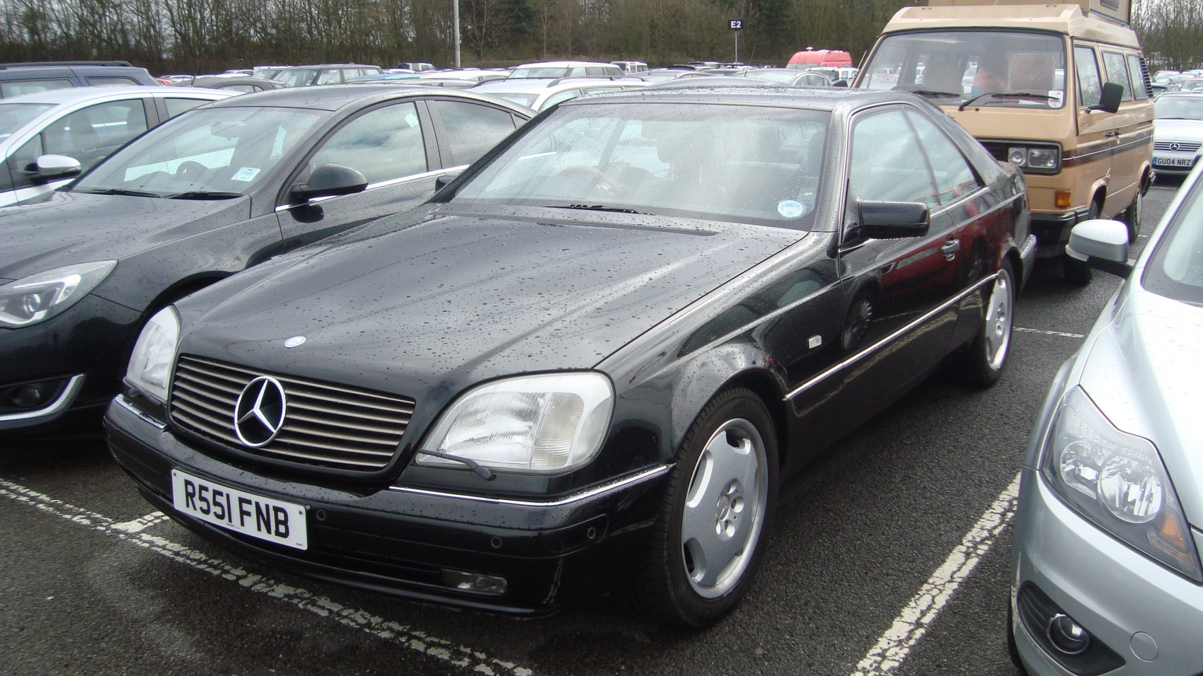 Black luxury coupe with prominent grille and aerodynamic shape