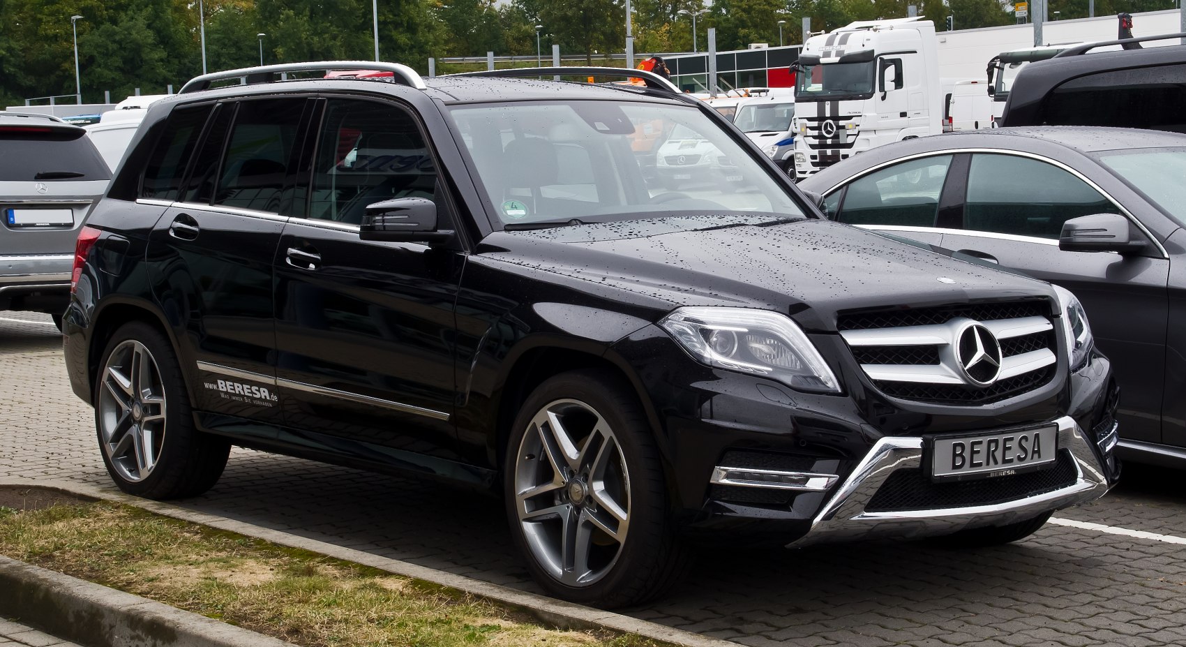 Black SUV with chrome grille, LED headlights, and alloy wheels