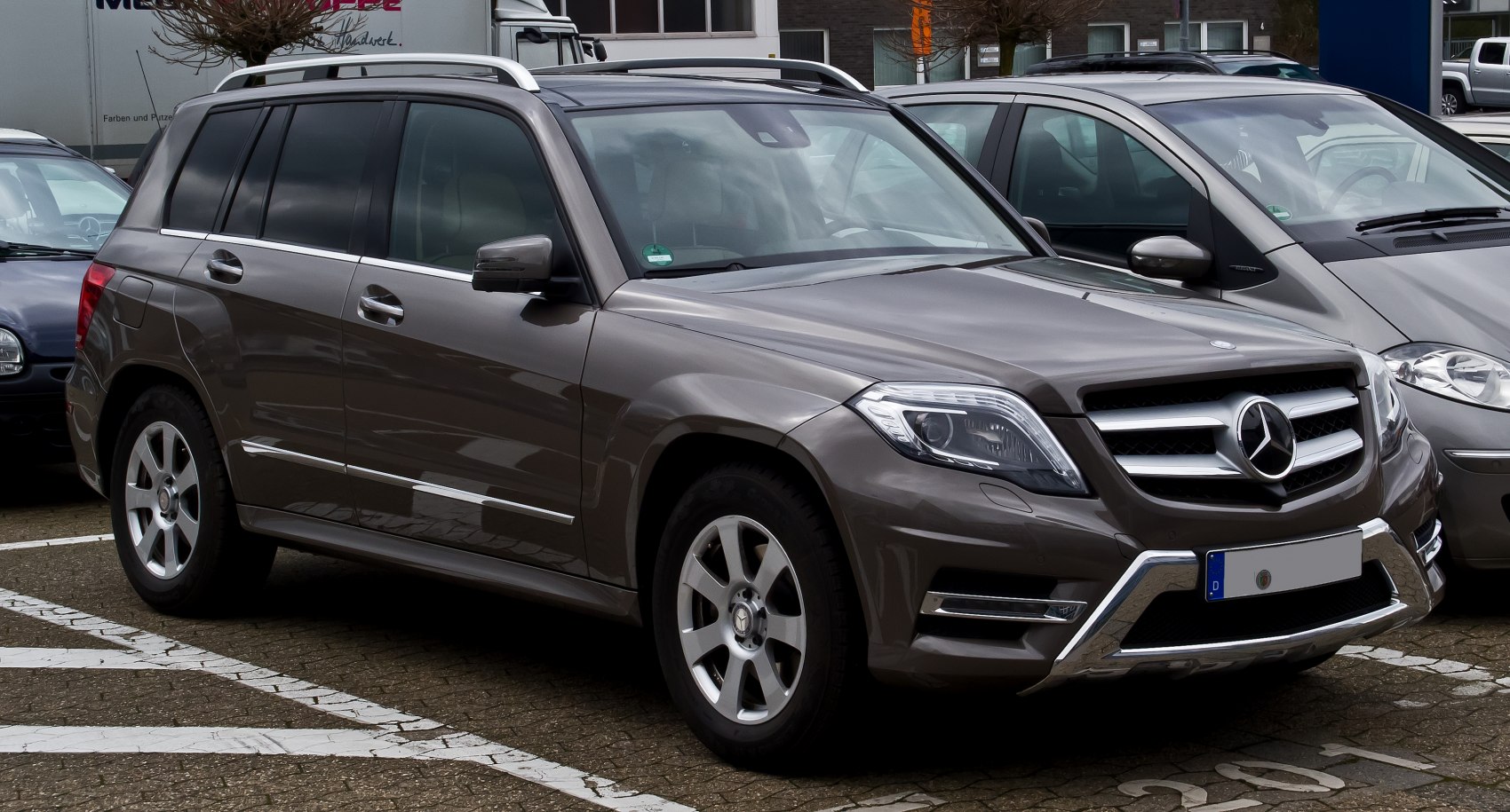 Compact luxury SUV front side with bold grille and roof rails