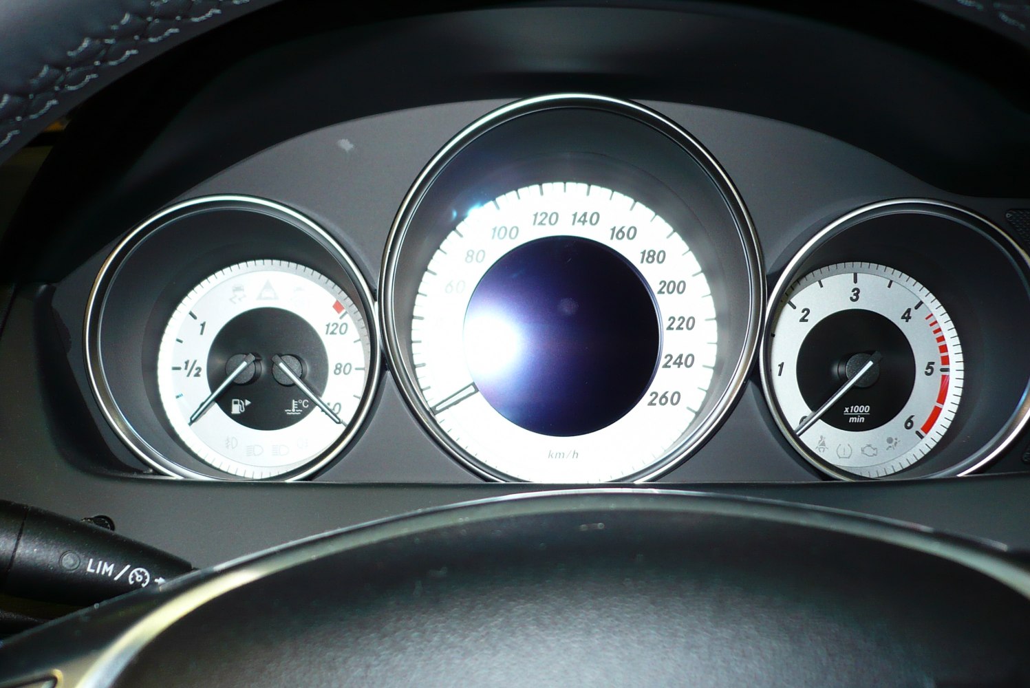 Close-up of speedometer, tachometer, and fuel/temp gauges in car instrument cluster