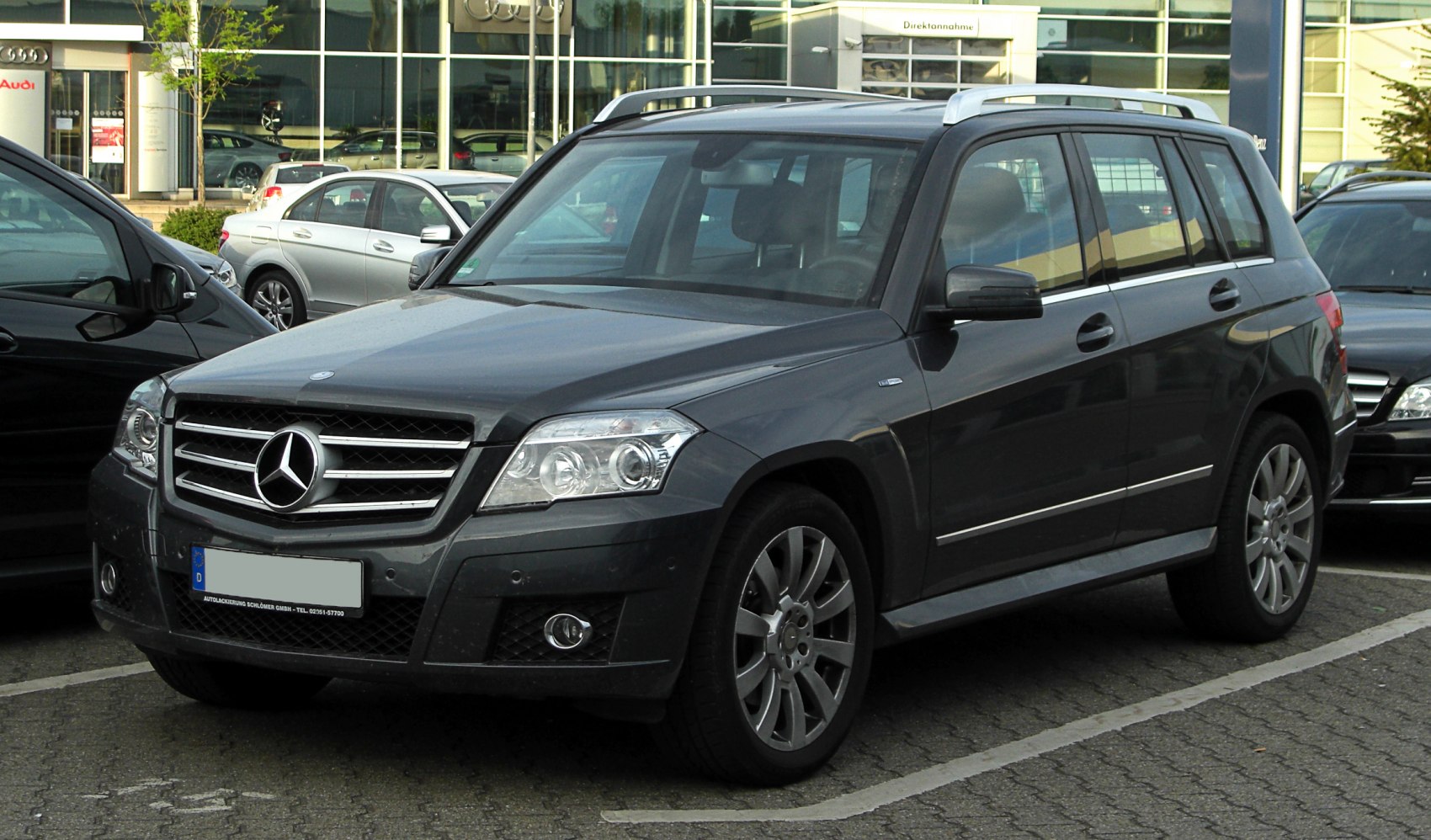 Front angled SUV with prominent grille, LED headlights, and roof rails