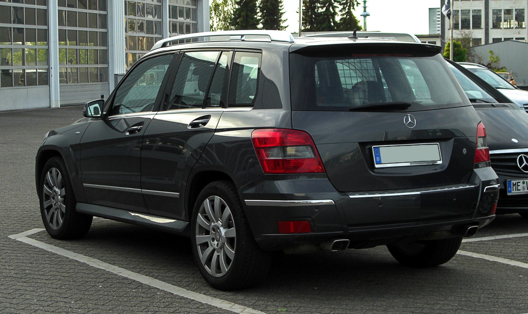 Rear side view of a luxury SUV with chrome details and alloy wheels.