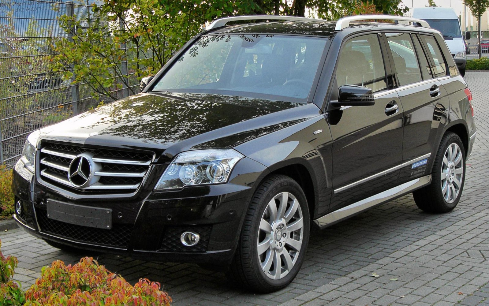 Black SUV with front grille, headlights, alloy wheels, and roof rails