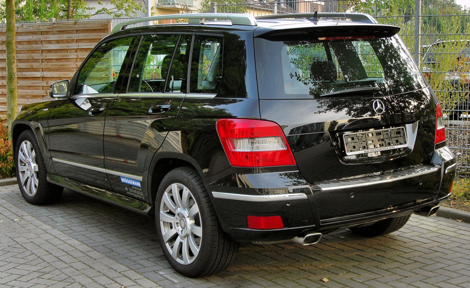Rear and side view showing taillights, alloy wheels, roof rails