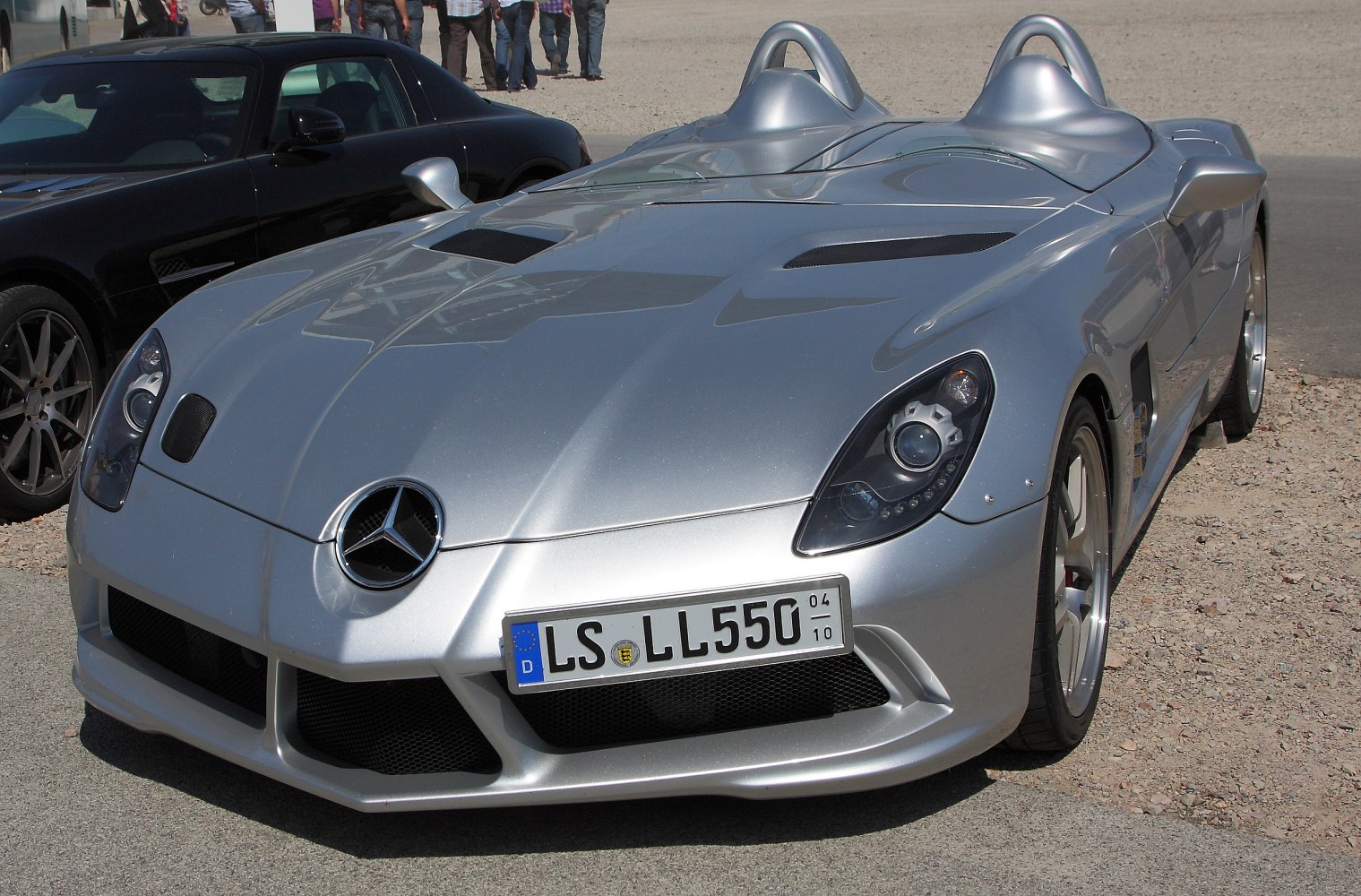 Silver roadster with dual cockpit and aerodynamic hood vents