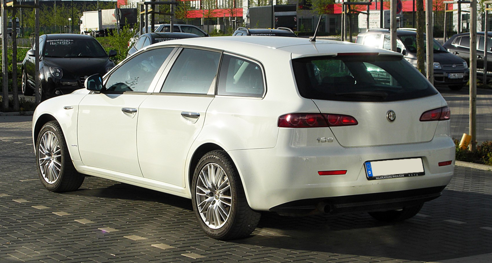 White station wagon rear-side view with alloy wheels