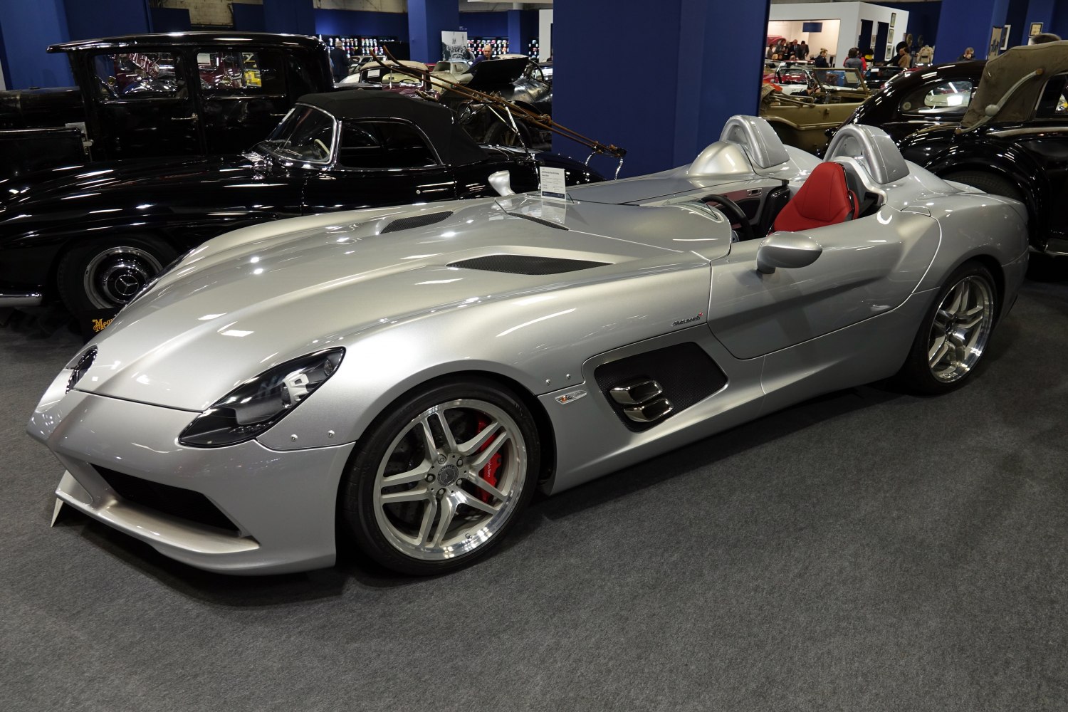 Silver aerodynamic open two-seater roadster with red seat