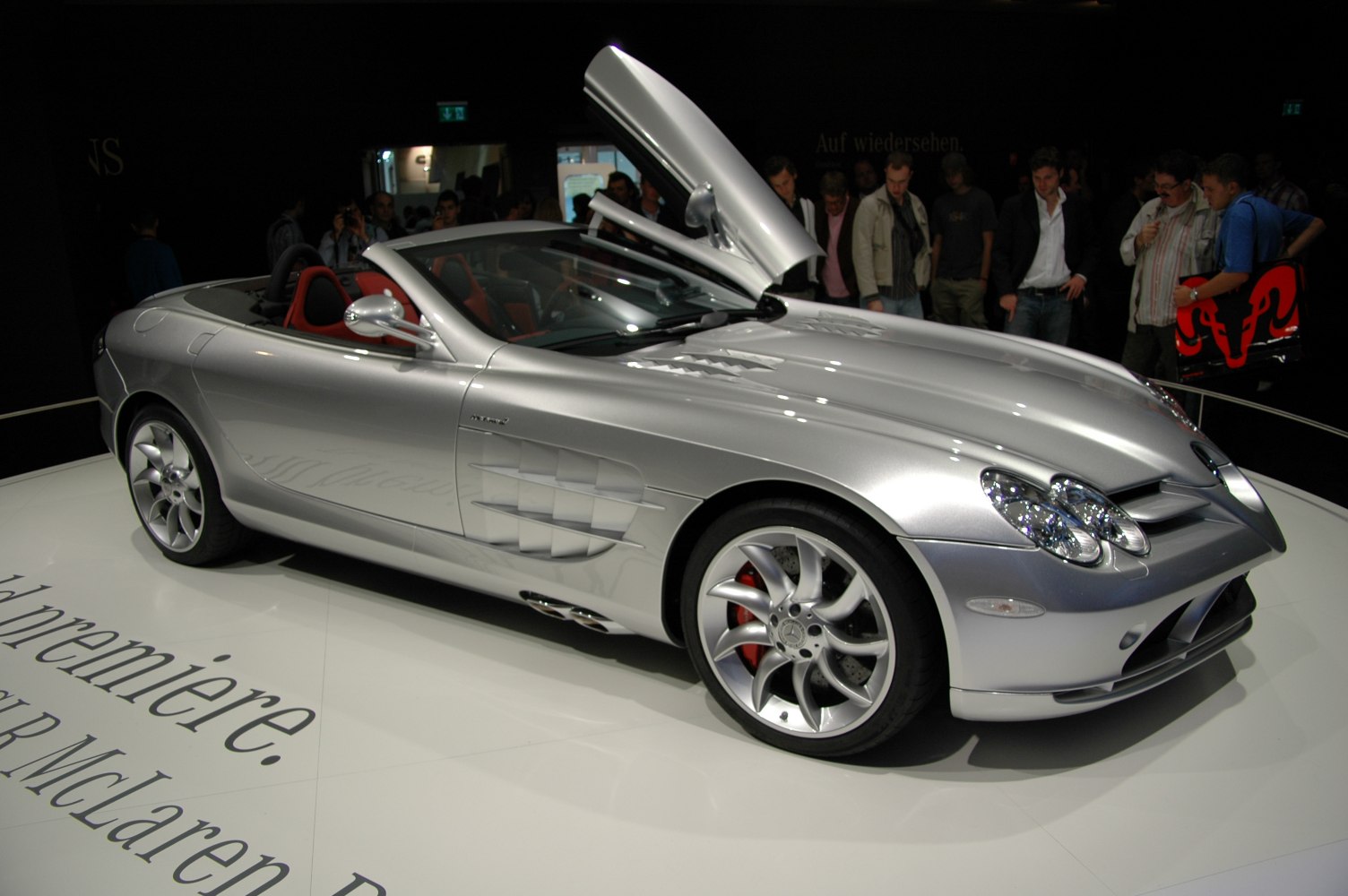 Sleek silver convertible with gullwing doors and aerodynamic side vents