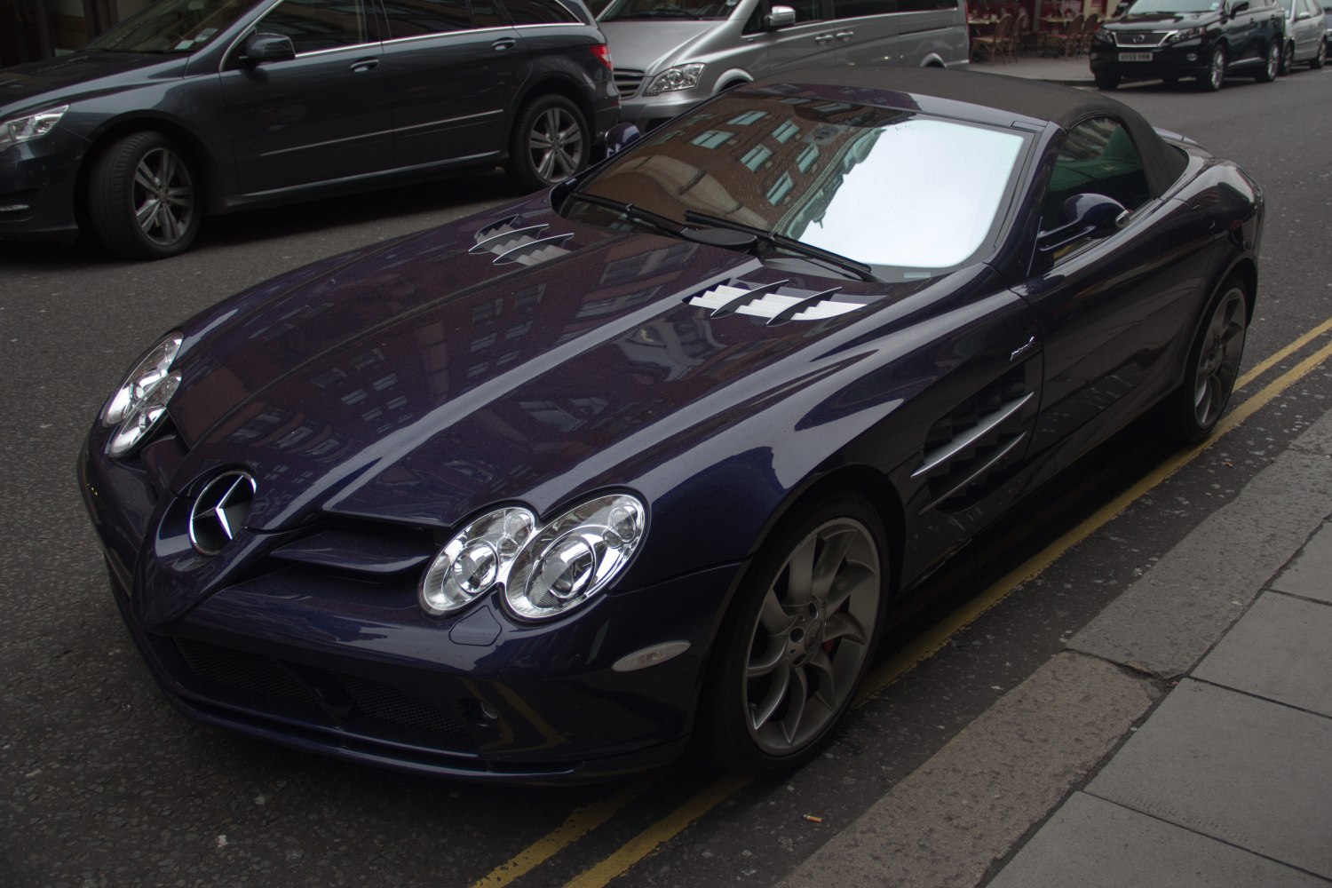 Convertible sports car with prominent hood vents and sleek aerodynamic design