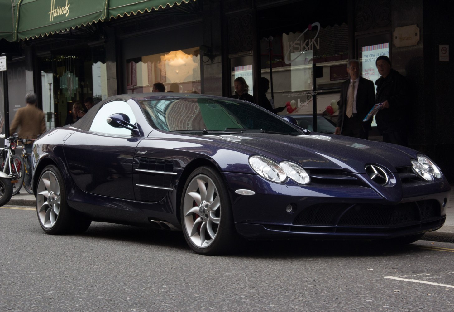 Front side view of luxury soft top convertible with distinctive headlights and alloy wheels