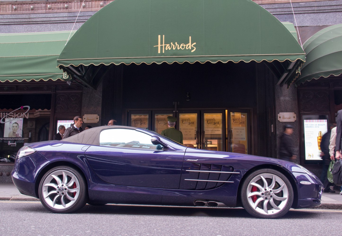 Side profile of a sporty convertible with distinctive side vents and alloy wheels.