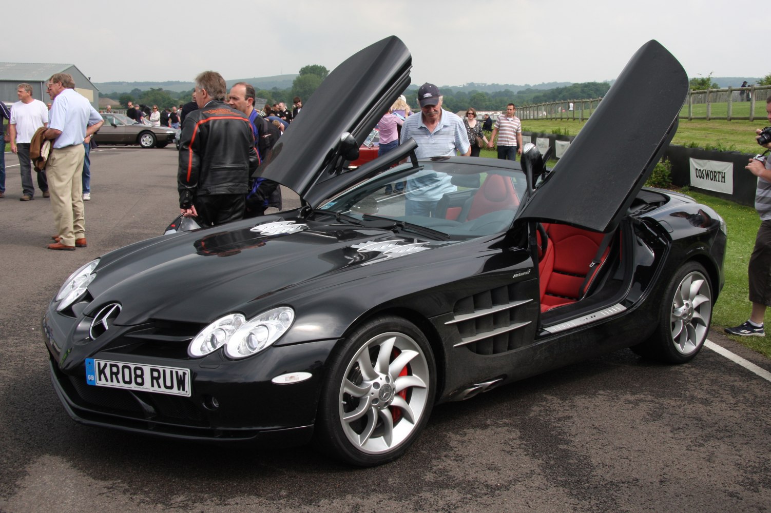 Black convertible with gullwing doors and red interior seats