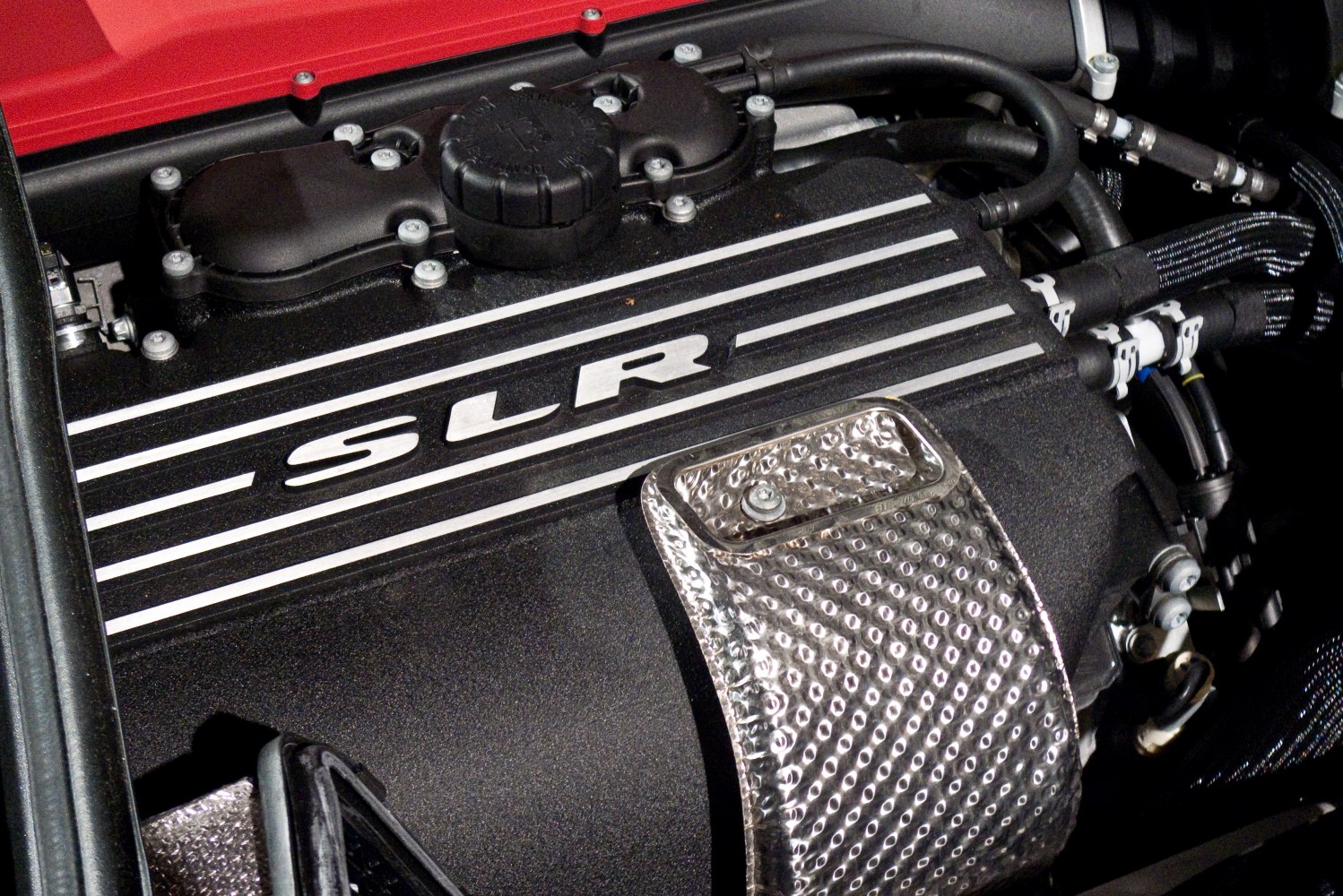 Close-up of engine cover with SLR logo and heat shield