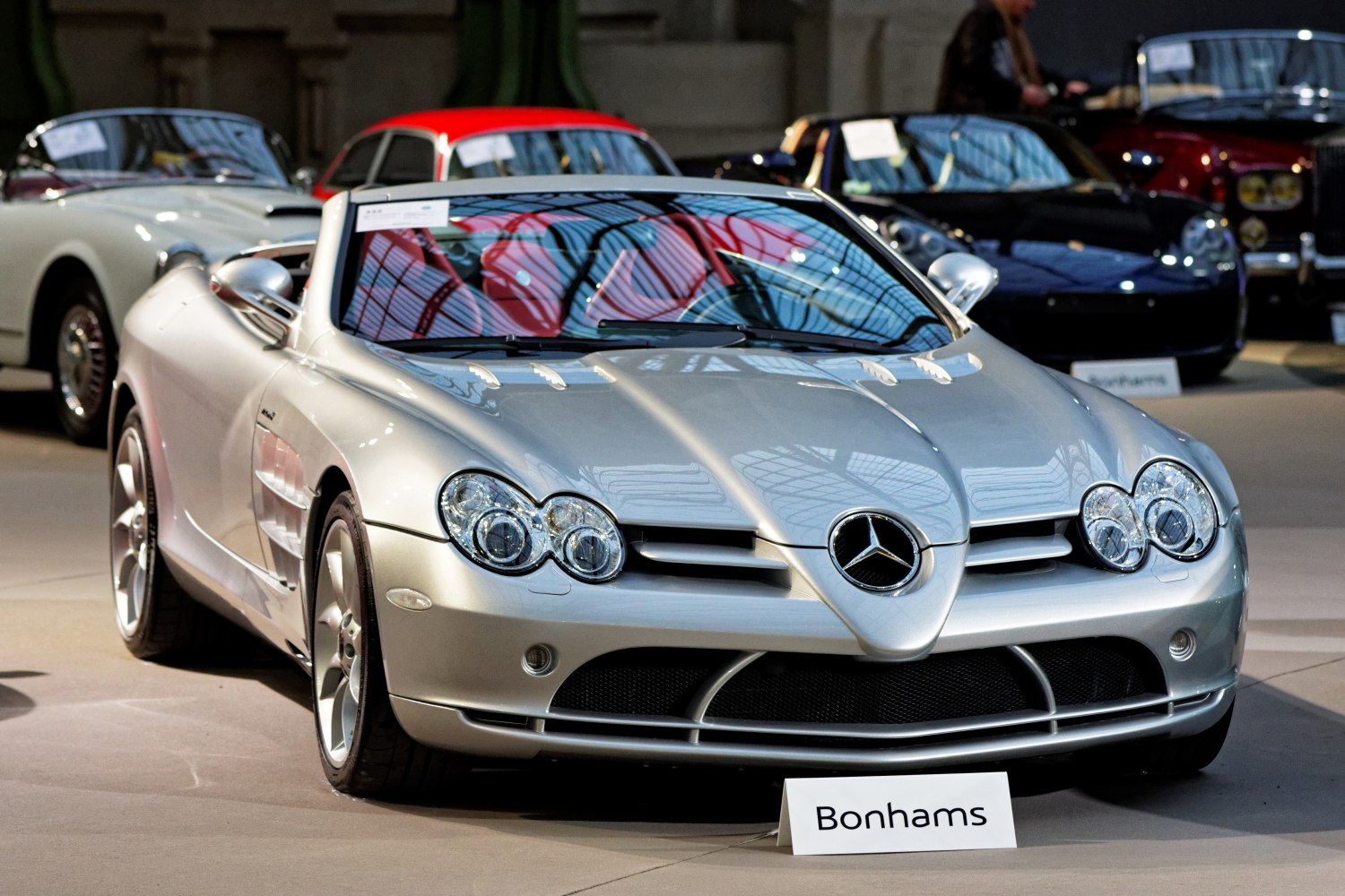 Silver convertible with quad headlights and distinctive front grille