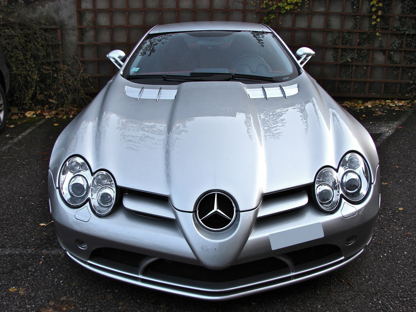 Front view with distinctive triple round headlights and hood vents