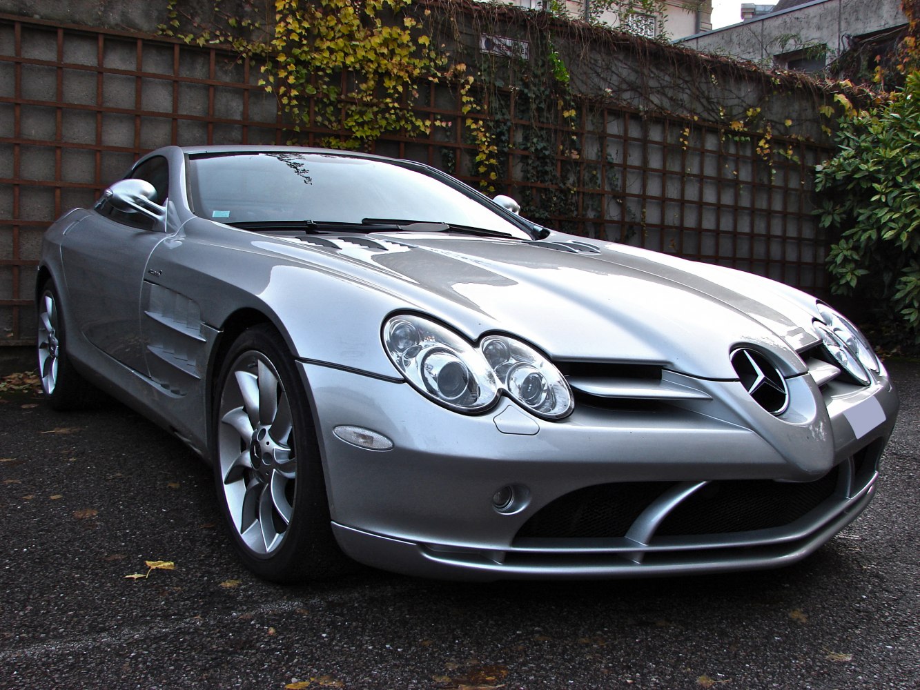 Silver luxury coupe with distinctive headlights and aerodynamic front design