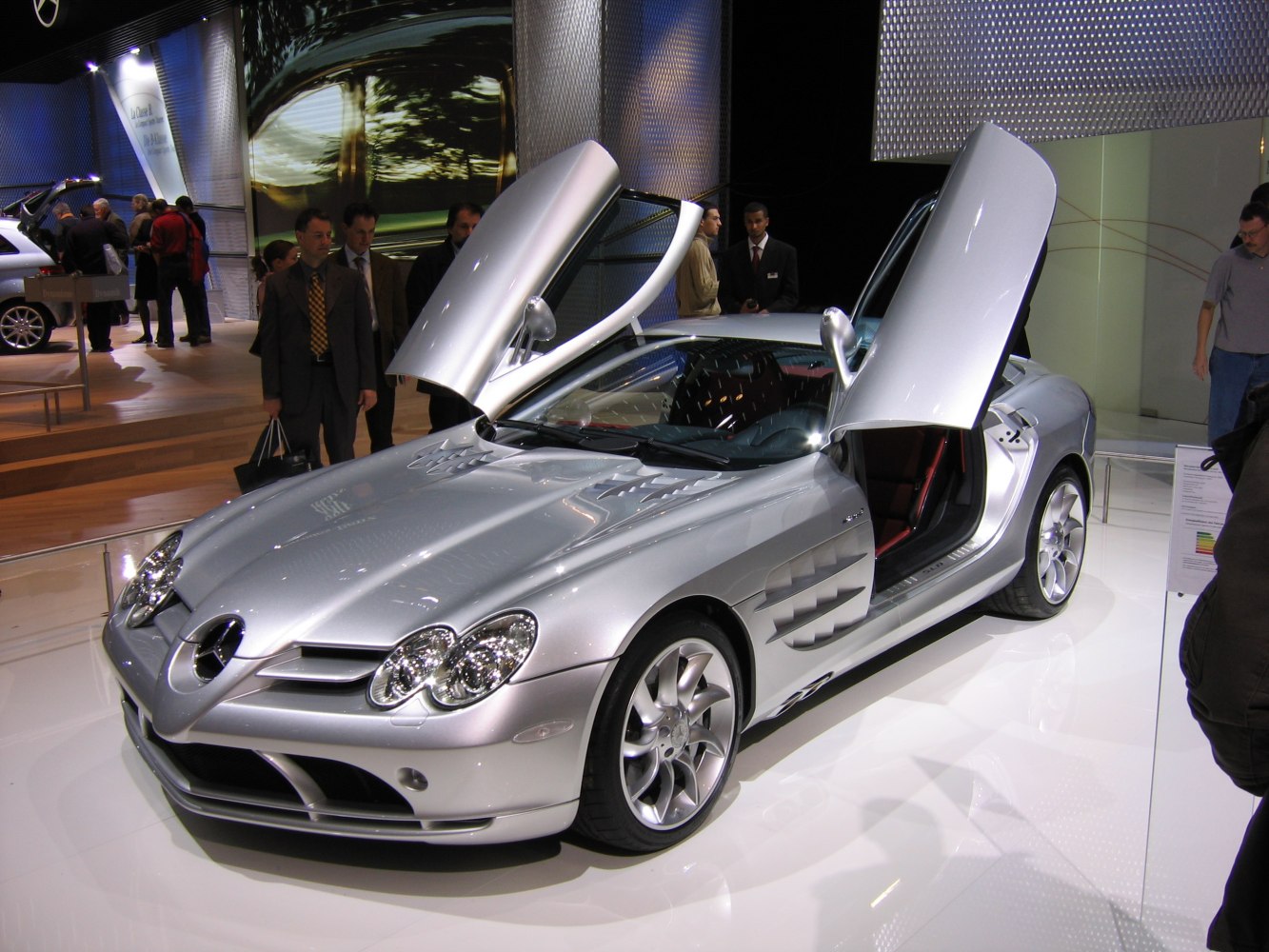 Silver sports coupe with gullwing doors and distinctive front design