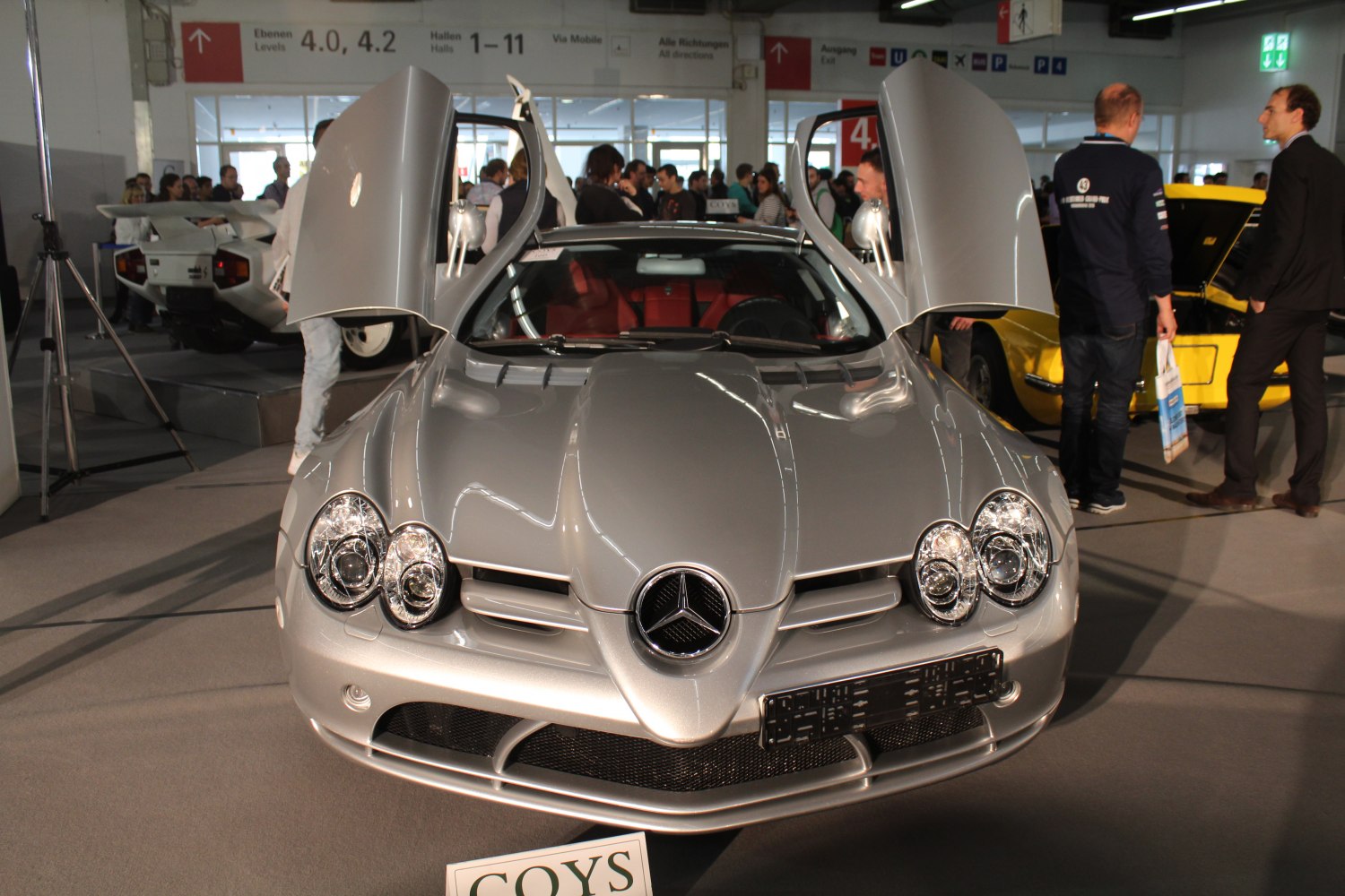 Front view with distinctive headlights and open gullwing doors.