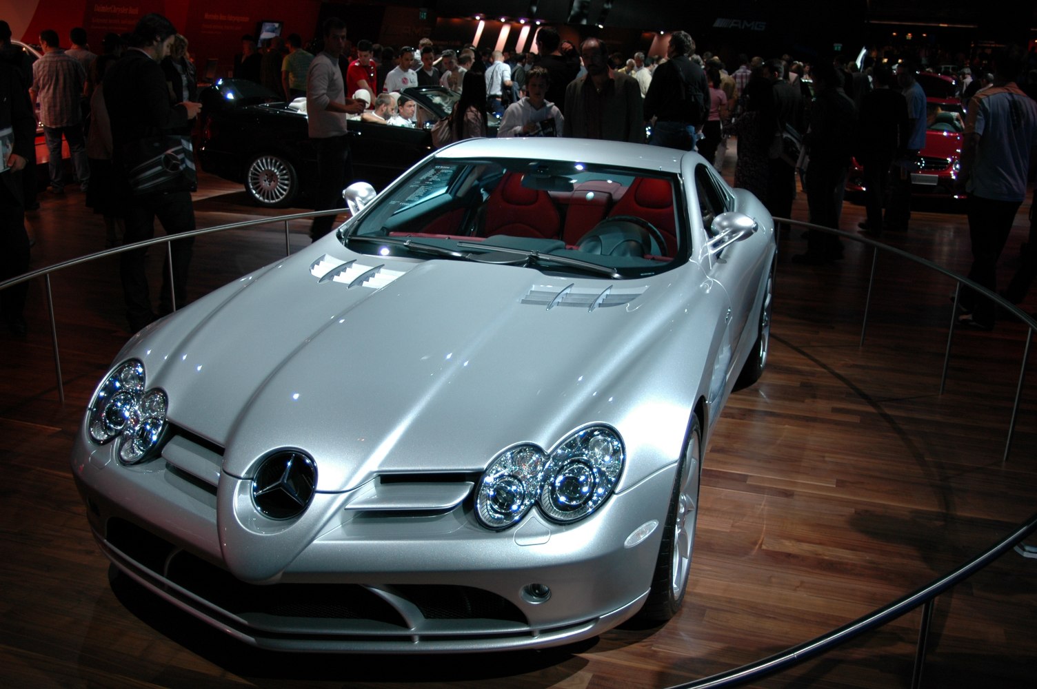 Silver sports coupe with quad headlights and hood vents