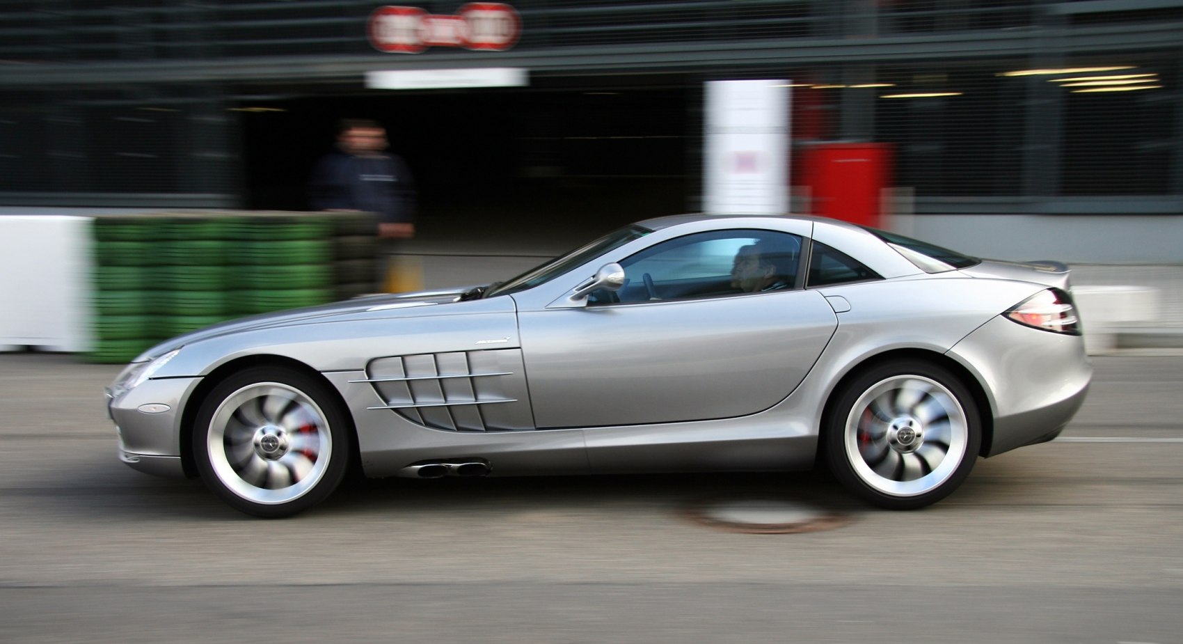 Silver coupe with side vents and spinning wheels