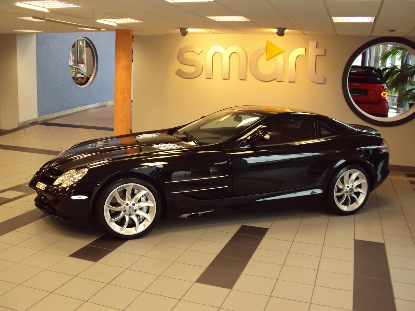 Sleek black coupe with side vents and sporty alloy wheels