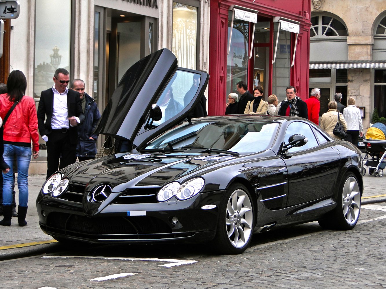 Black supercar with gullwing door open and sleek coupe body